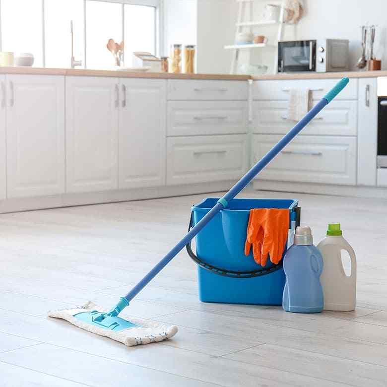 Cleaning supplies and mop in a modern kitchen for affordable house cleaning for the Kirkland community