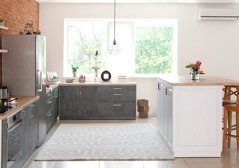 Modern, spotless kitchen with natural light and wood accents, representing recurring house cleaning in Bellevue kitchen.