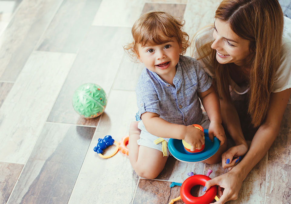 Mother and child on freshly cleaned floors in a Kirkland home during holiday preparation.