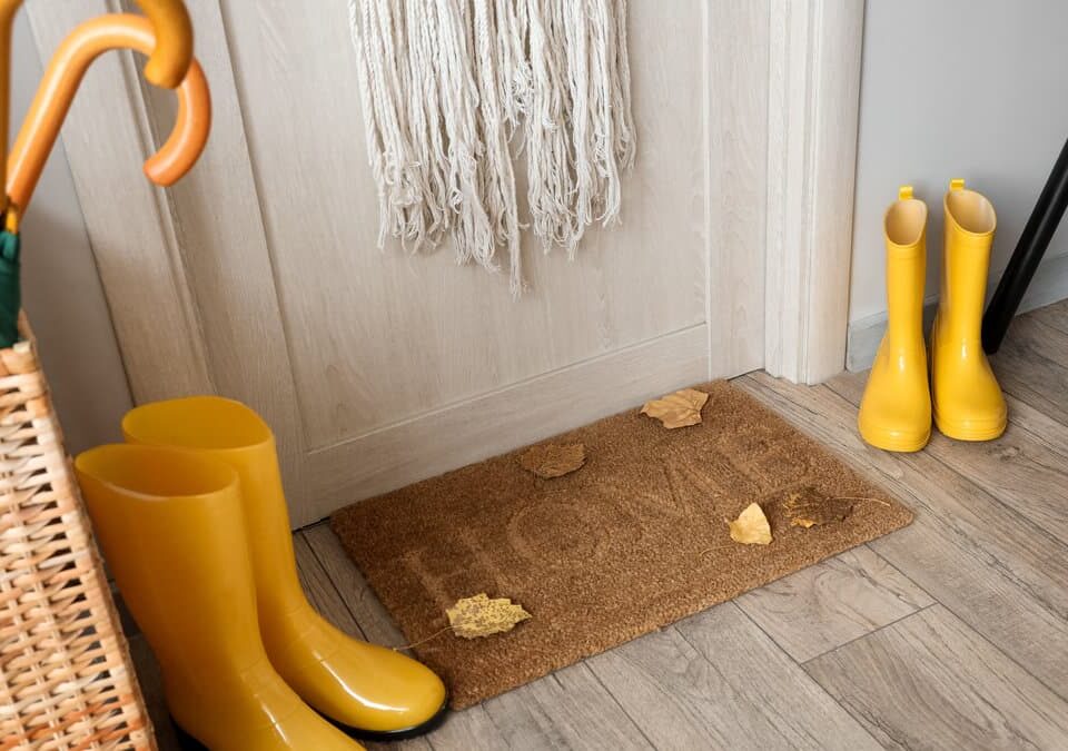 Rainy winter entryway in a Kirkland home with boots, umbrella, and doormat collecting mud and moisture to protect floors during winter deep cleaning