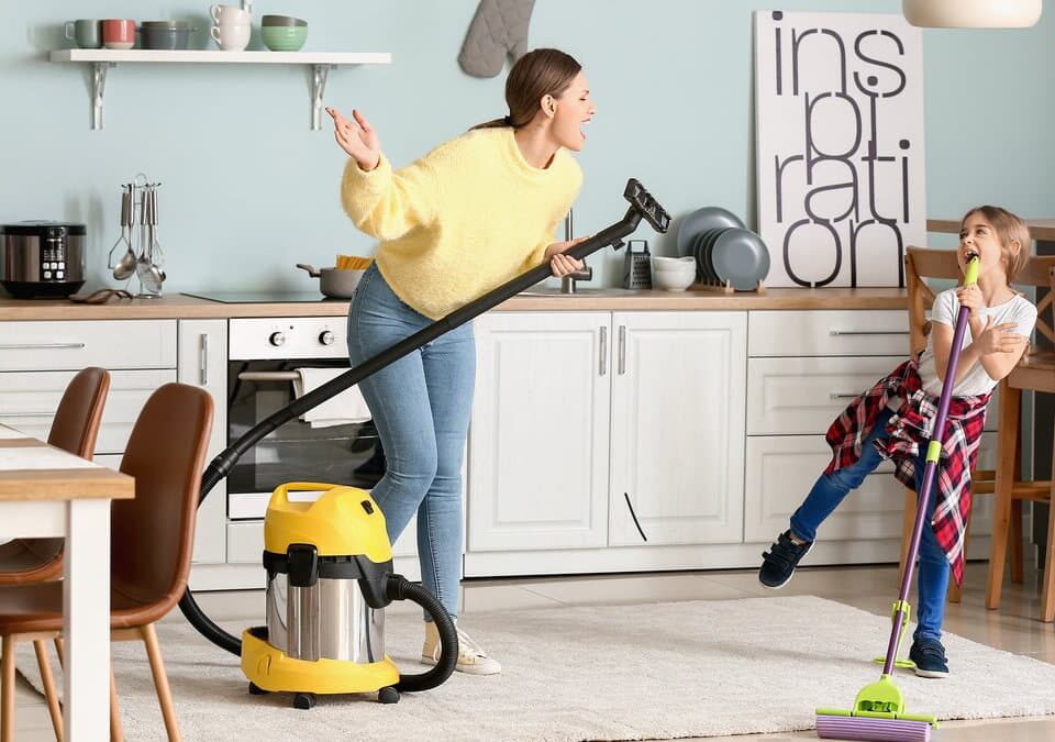 Kitchen cleaning checklist for Bellevue homeowners with a parent vacuuming and a child helping in the kitchen.